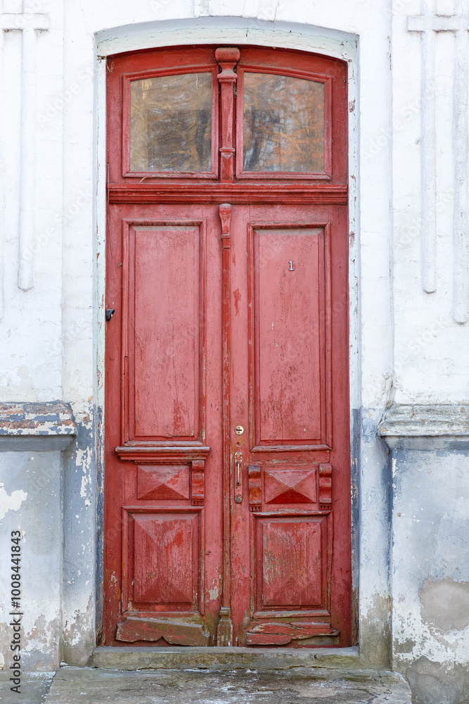 Old traditional painted wooden door with handle. Ancient closed wooden front door. Vertical photo Old traditional painted wooden door with handle. Ancient closed wooden front door. Vertical photo