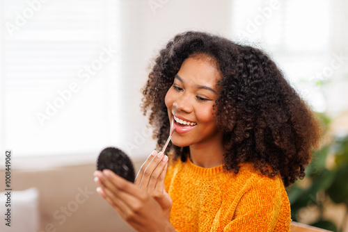 Asian young African Americanwoman looking in mirror worry about pores facial skin problem with acne and dry skin,Skin care concept
 photo