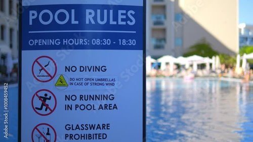 Pool rules sign with swimming pool in resort background in 4k slow motion 60fps