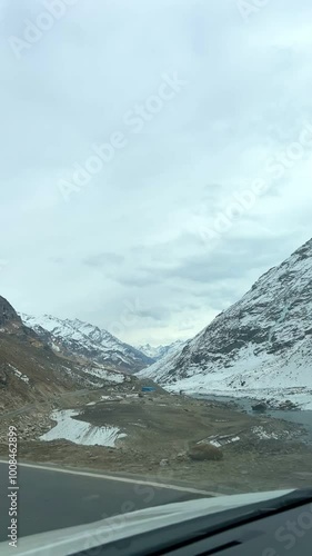 MANALI, INDIA - January 9, 2024: Atal Tunnel Indian highway tunnel built under the Rohtang Pass in Himalayas.Snow mountains landscape.Winter ride between snow mountains in Manali Himachal Pradesh.