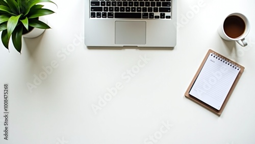 A clean workspace showcases a laptop, clock, notebook, coffee cup, and pen, creating an inviting atmosphere for studying or working efficiently.
