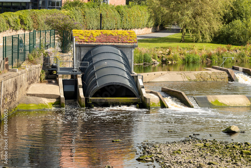 River Hydro Electric Scheme in Town with Archimedean Single Screw Turbine Power House and Fish Ladder photo