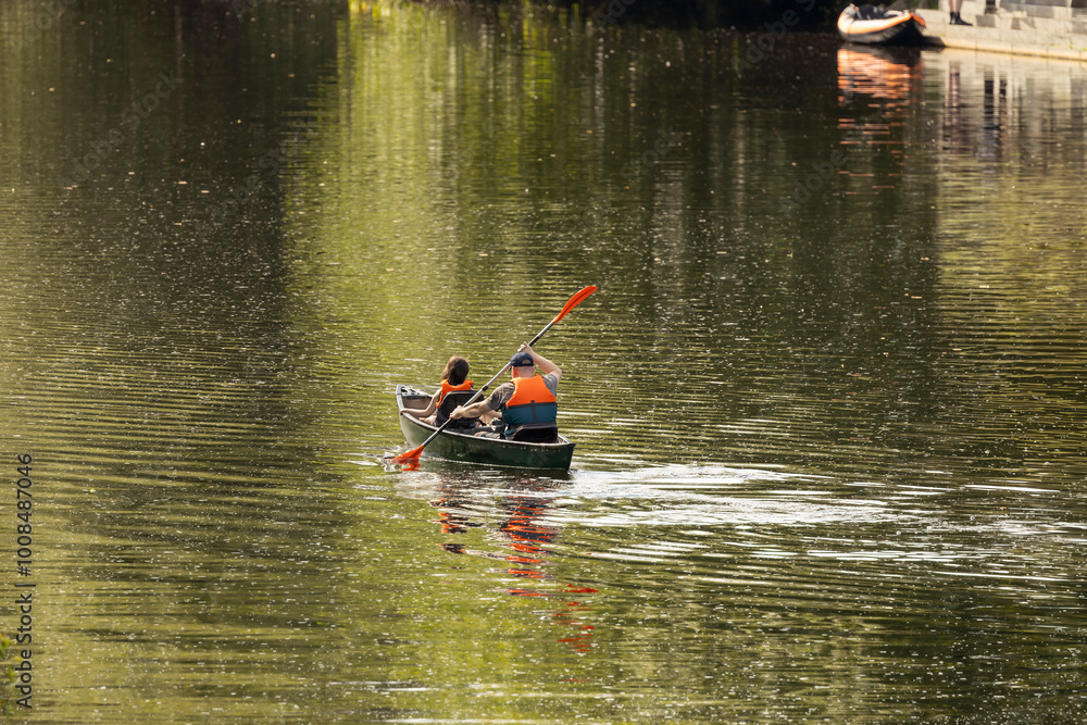 Father and daughter canoeing on calm river in UK for a summertime adventure Father and daughter canoeing on calm river in UK for a summertime adventure