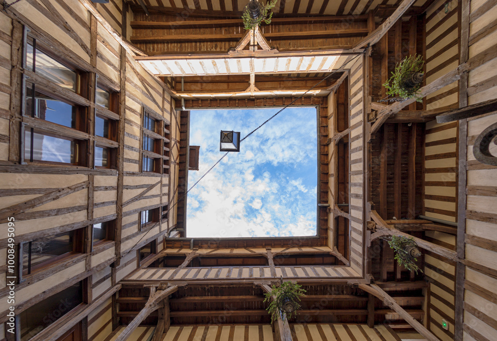 Patio of half-timbered tenement building at Troyes, France. View up to the sky. Patio of half-timbered tenement building at Troyes, France. View up to the sky.