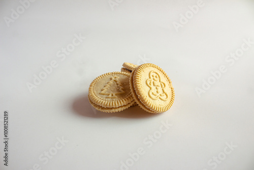 Round cookies with including Christmas symbols such as trees, snowmen and other holiday characters. Vanilla or butter sandwich cookies.