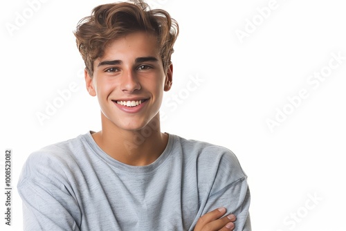 Smiling young male model with crossed arms, isolated on a white setting , background blur