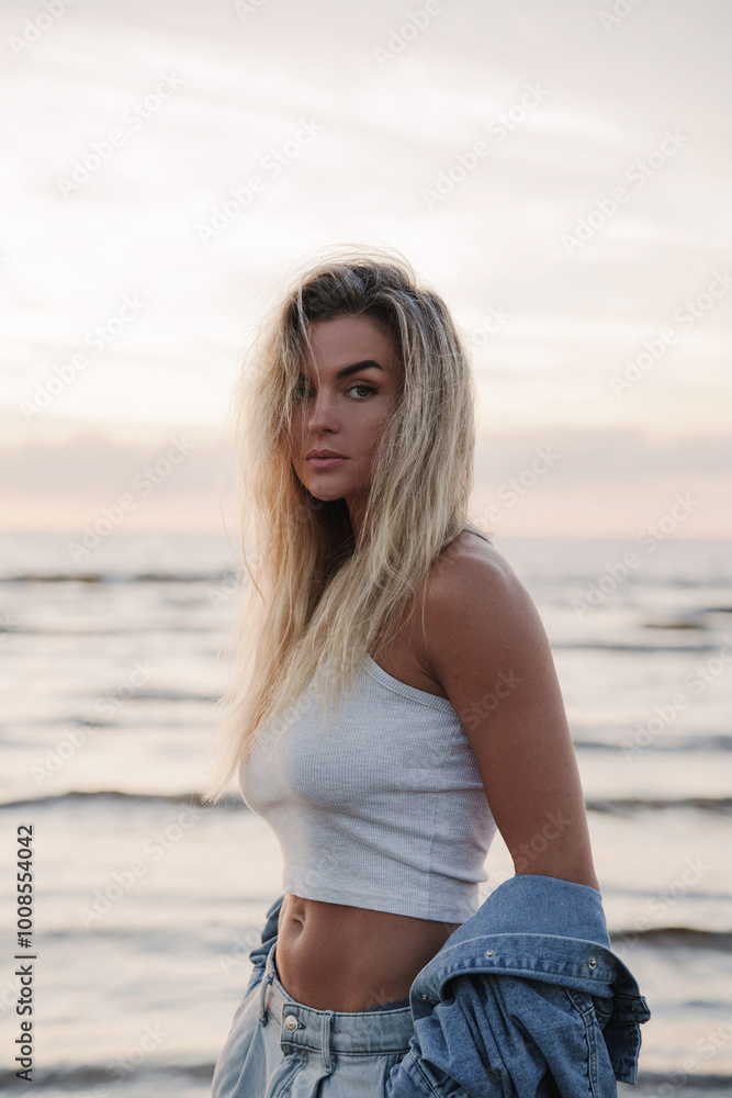 Young Stylish Woman Enjoying Sunset by the Beach Young Stylish Woman Enjoying Sunset by the Beach