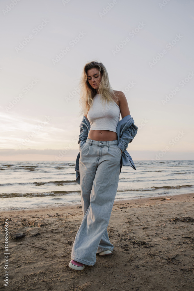 Young Stylish Woman Enjoying Sunset by the Beach Young Stylish Woman Enjoying Sunset by the Beach