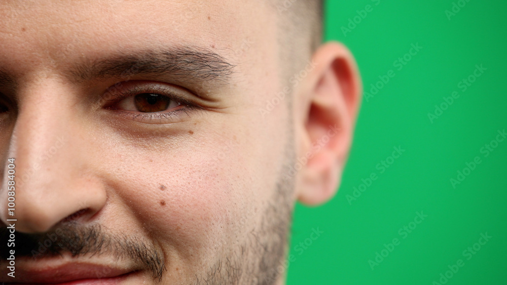 Fototapeta premium Man's face, close-up, on a green background