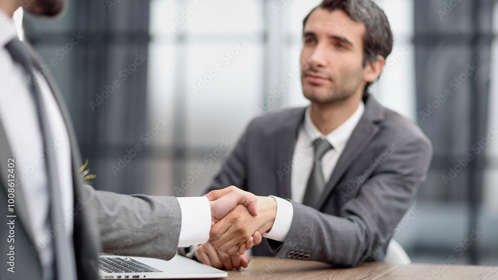 Portrait of cheerful young manager handshake with new employee. Portrait of cheerful young manager handshake with new employee.