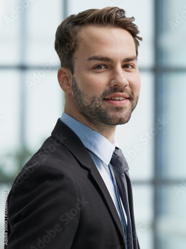 Portrait of a happy man wearing glasses and looking at the camera indoors.