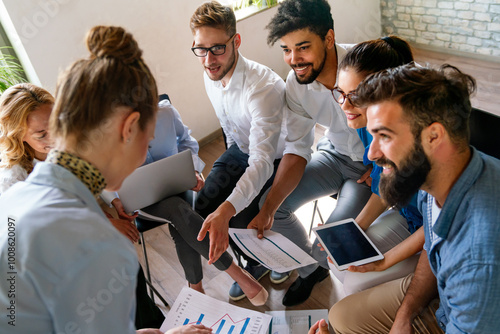 Group of young multi-ethnic startup business team collaborating on project in modern office photo