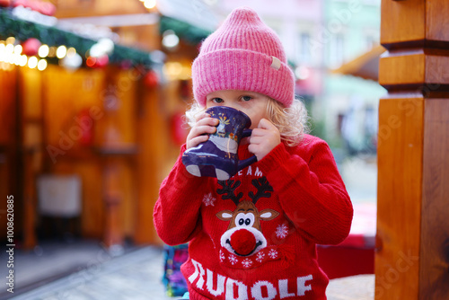 little girl drink tea at the Christmas market in Wroclaw Poland photo