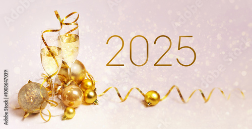 Congratulations on the New Year 2025. 2 glasses of champagne, golden streamers and golden Christmas balls on a pink background