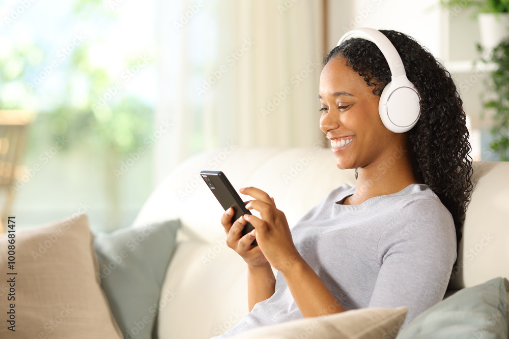 Happy black woman choosing music on smart phone Happy black woman choosing music on smart phone