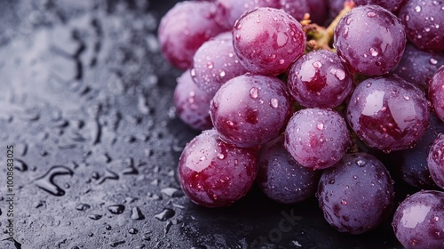Wallpaper Mural This image displays a bunch of fresh, plump purple grapes covered in water droplets, placed on a dark surface, highlighting their lush and enticing appearance. Torontodigital.ca