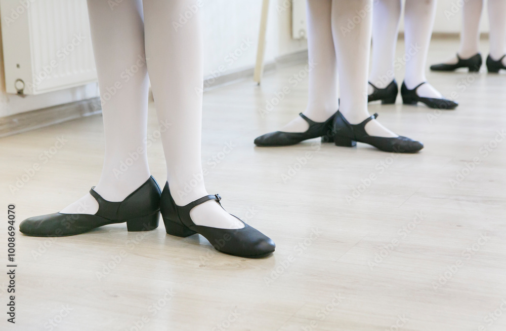 feet in black dancing shoes are standing on the dance floor, classic feet in black dancing shoes are standing on the dance floor, classic