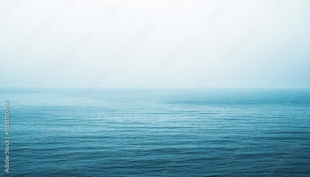 Fototapeta premium Calm Ocean Under a Foggy Sky