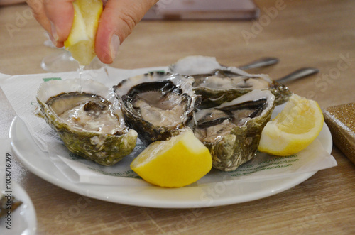 Plate of fresh raw oysters Mussels with a lemon.