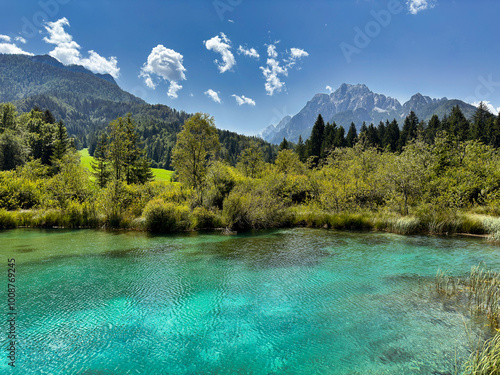 clear turquoise alpine lake against the lush greenery and mountain peaks. landscape background. nature. Julian alps. Slovenia