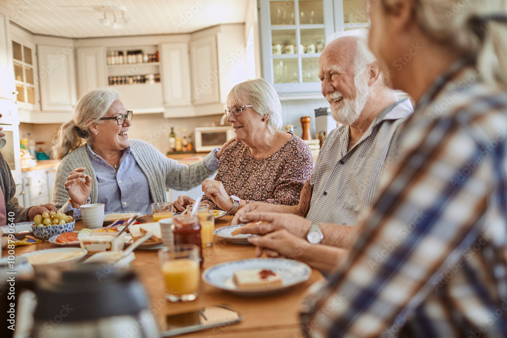 Seniors enjoying breakfast together in cozy kitchen Seniors enjoying breakfast together in cozy kitchen