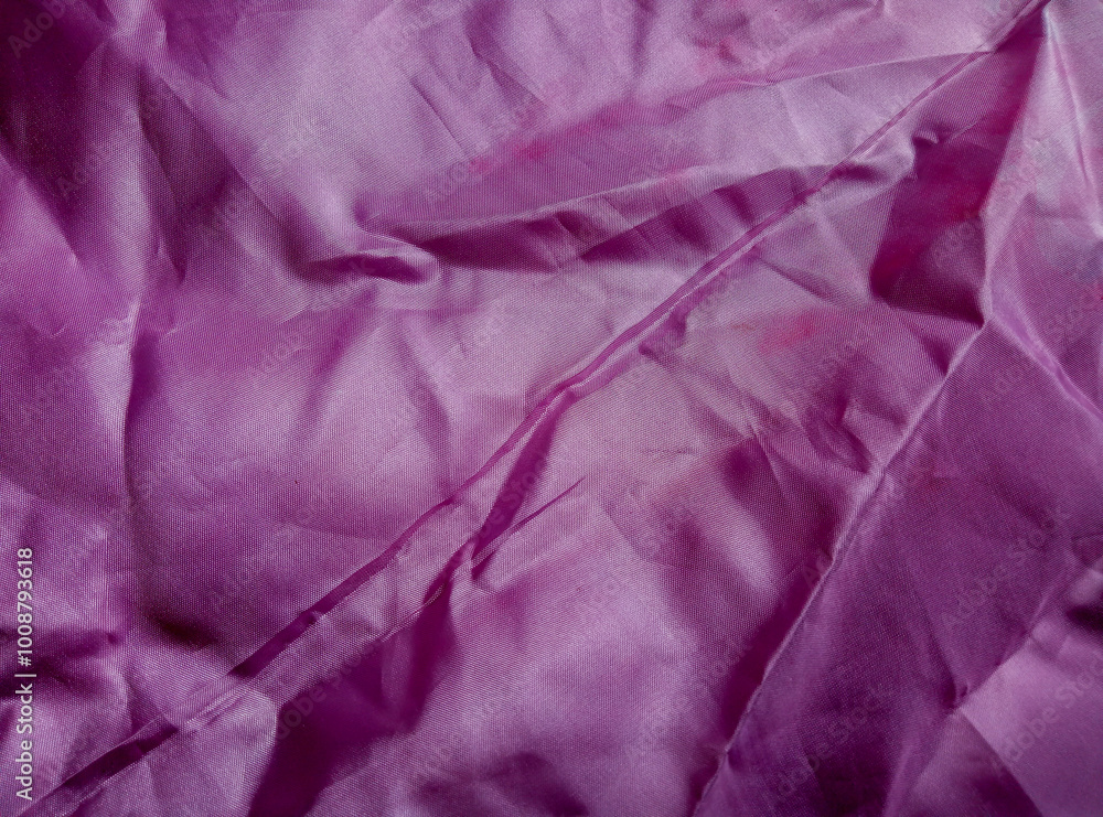 purple cotton fabric with wrinkled and wavy surface. Fabric texture and background. purple satin fabric purple cotton fabric with wrinkled and wavy surface. Fabric texture and background. purple satin fabric