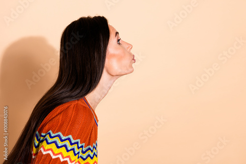 Profile portrait of pretty young lady kiss empty space wear t-shirt isolated on beige color background