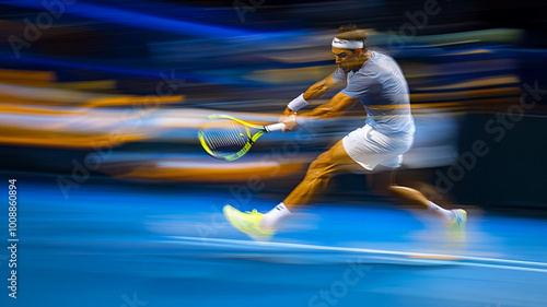 A professional tennis player performs a powerful backhand stroke during a nighttime match photo