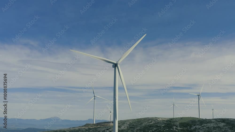 Wind turbines on blue cloudy sky, Wind farm, aerial drone view. Green ecological power energy generation. Alternative energy plant Wind turbines on blue cloudy sky, Wind farm, aerial drone view. Green ecological power energy generation. Alternative energy plant
