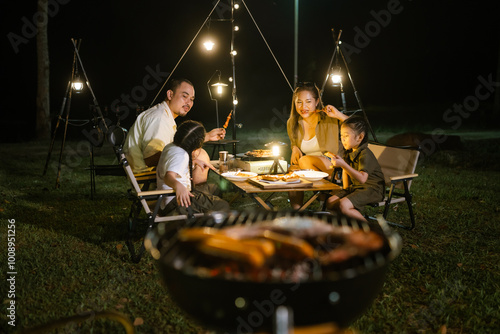 Konstfotografi Asian father, mother and daughter are enjoying dinner and camping in nature