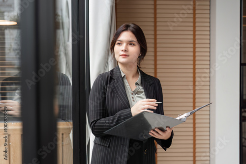 Confident Businesswoman in Modern Office Holding Documents and Planning Future Strategies Free Download Confident Businesswoman in Modern Office Holding Documents and Planning Future Strategies - GFXLoad