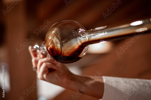 The decanting of balsamic vinegar is traditionally done with a glass instrument that in addition to decanting allows for quality control.