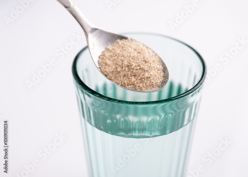 Whole Psyllium Husks Being Mixed with Water for Fiber Supplementation photo