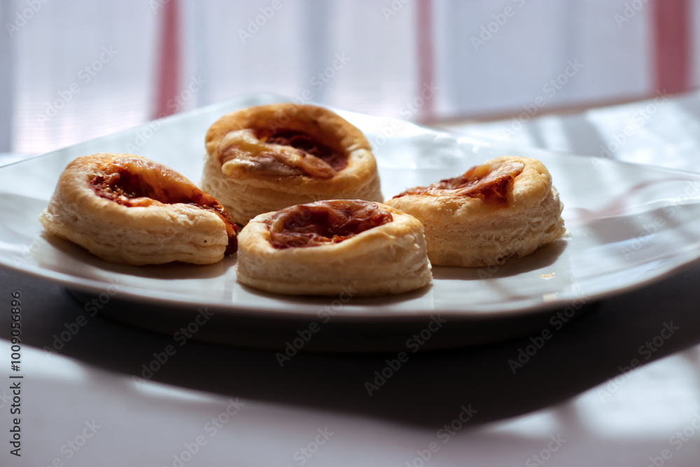 Small Italian pizzas on a white plate. Small Italian pizzas on a white plate.
