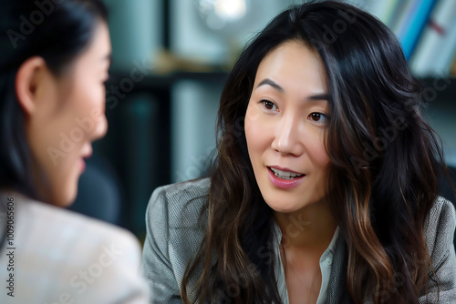 Asian businesswoman talking to her colleague in the office