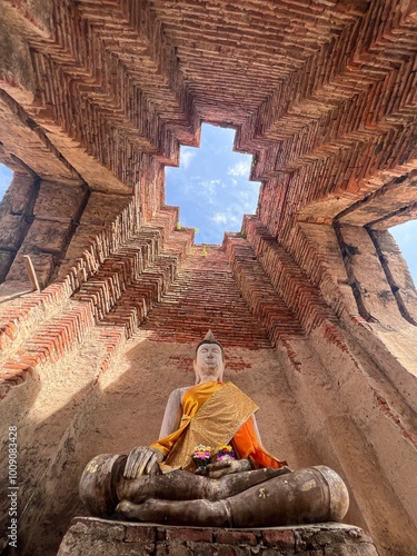 Buddha statue in ruined building.