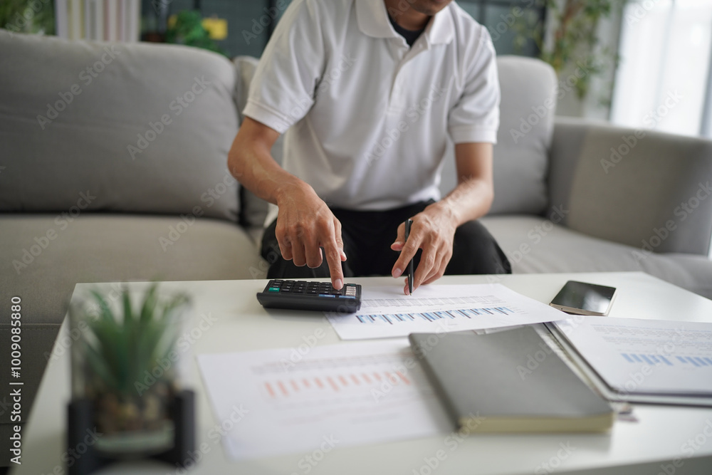 Man using calculator calculate finance and another hand holding pen Man using calculator calculate finance and another hand holding pen