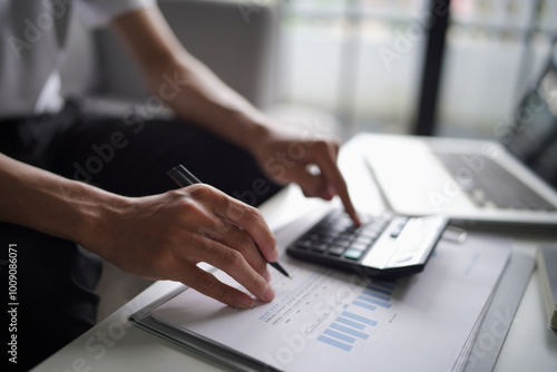 Man using calculator calculate finance and another hand holding pen