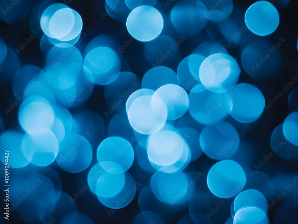 Blurred light blue circles on a dark background. Abstract bokeh lights. Blurred light blue circles on a dark background. Abstract bokeh lights.
