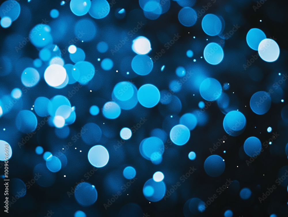Blurred light blue circles on a dark background. Abstract bokeh lights. Blurred light blue circles on a dark background. Abstract bokeh lights.