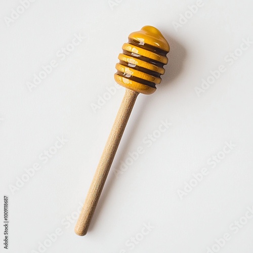 A wooden honey dipper with a glossy honey drizzle on top.