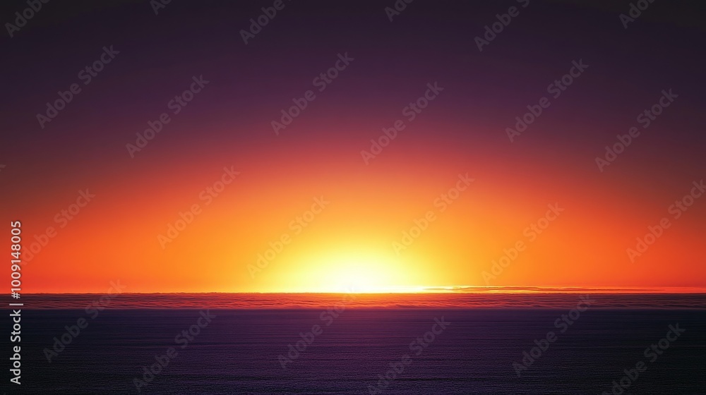 Obraz premium A vibrant orange sunset over the ocean with a deep purple sky.
