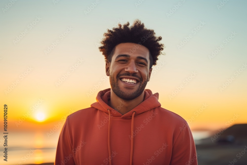 Portrait of a joyful afro-american man in his 30s sporting a trendy beanie while standing against vibrant sunset horizon Portrait of a joyful afro-american man in his 30s sporting a trendy beanie while standing against vibrant sunset horizon