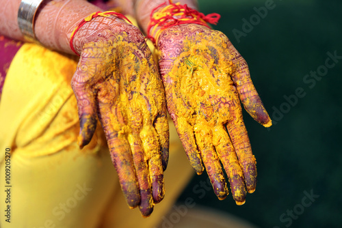 bride and groom's hands adorned with intricate henna designs and vibrant bangles, during a traditional Indian wedding ritual. photo