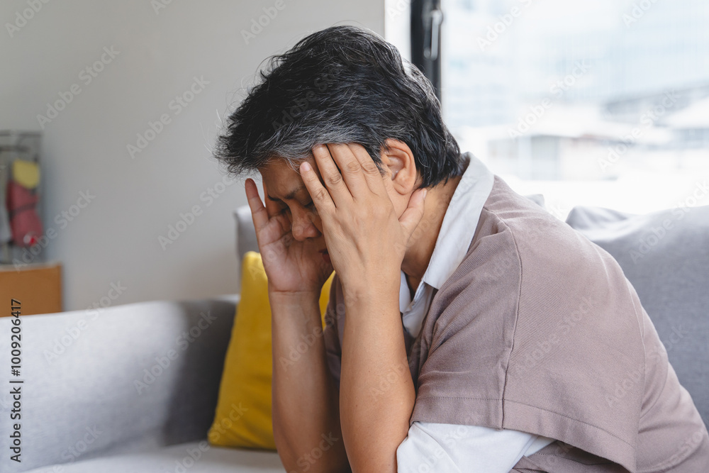 Elderly women feeling dizzy and headache sit on the sofa at home. Elderly women feeling dizzy and headache sit on the sofa at home.