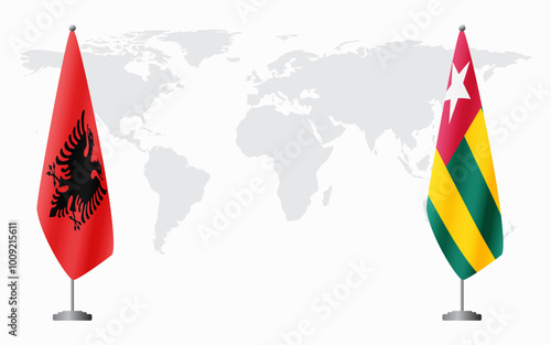 Albania and Togo flags for official meeting against background of world map. photo