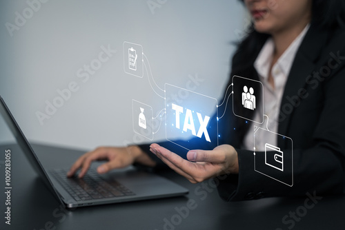 Close up of a mid adult woman checking her energy bills at home,  Busines using a computer to complete Individual income tax return form online for tax payment. photo