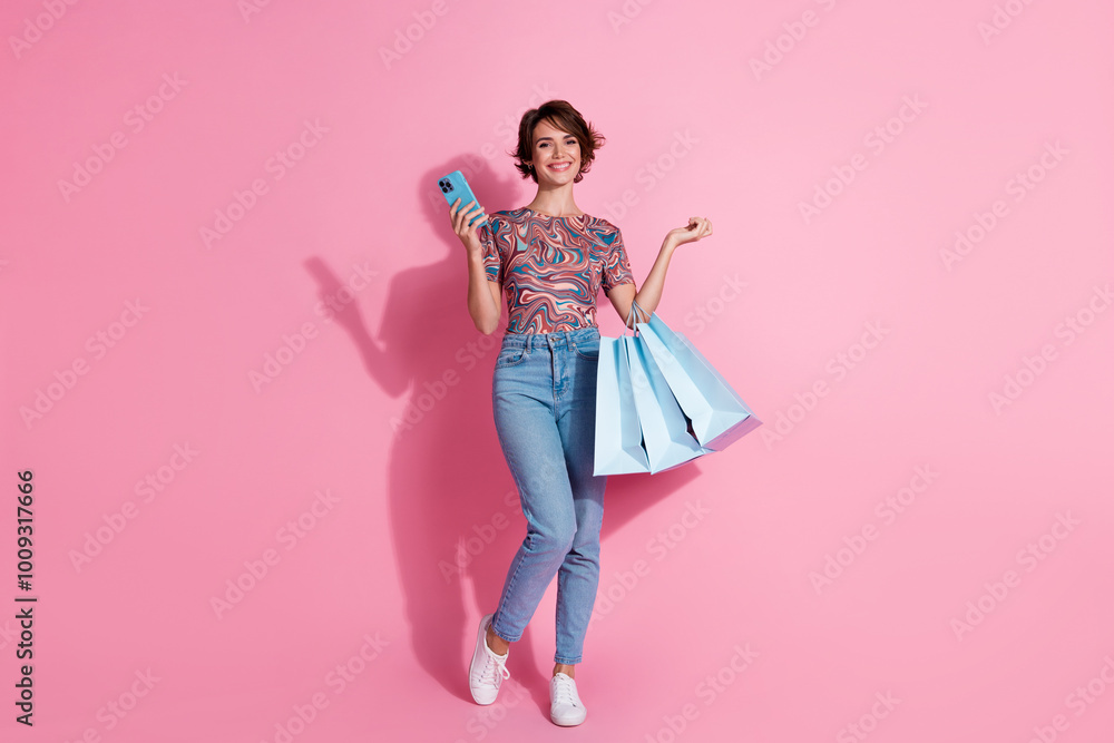 Photo of lovely charming girl wear stylish print clothes make order hold bags space isolated on pink color background Photo of lovely charming girl wear stylish print clothes make order hold bags space isolated on pink color background