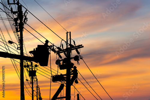 Silhouette of Electrician officer climbs a pole and uses a cable car to maintain a high voltage line system, Shadow of Electrician lineman repairman worker at climbing work on electric post power pole photo