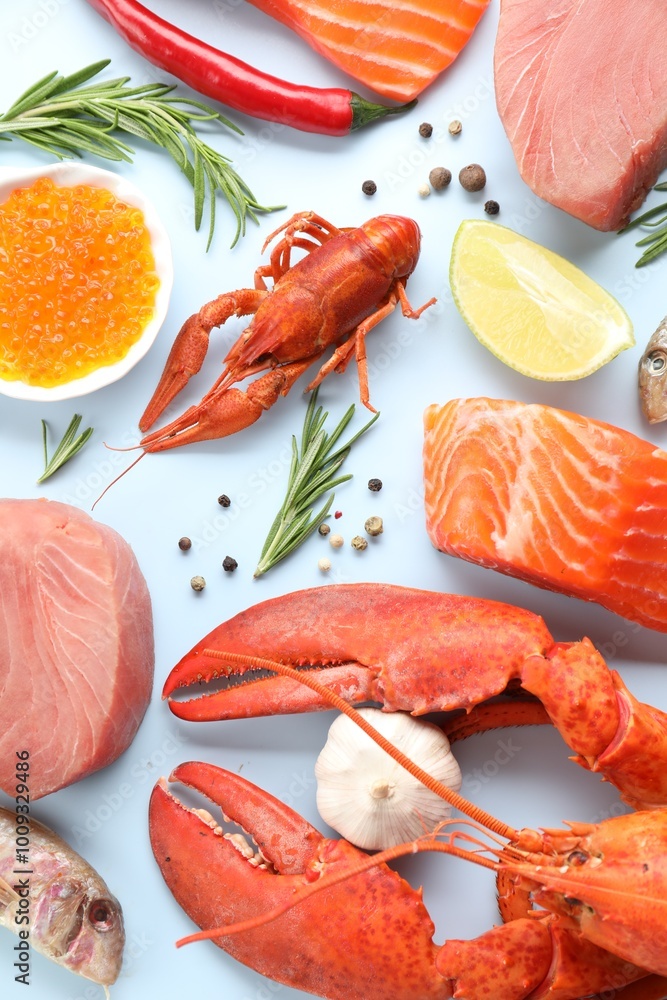 Many different sea food and spices on light blue background, flat lay Many different sea food and spices on light blue background, flat lay